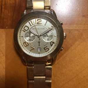 Men’s gold Michael Kors watch.